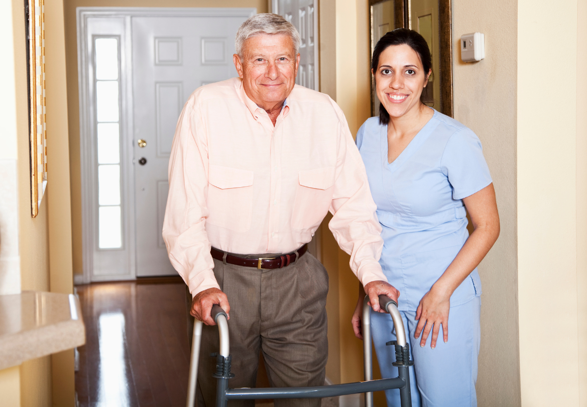 health care aide helping man walk